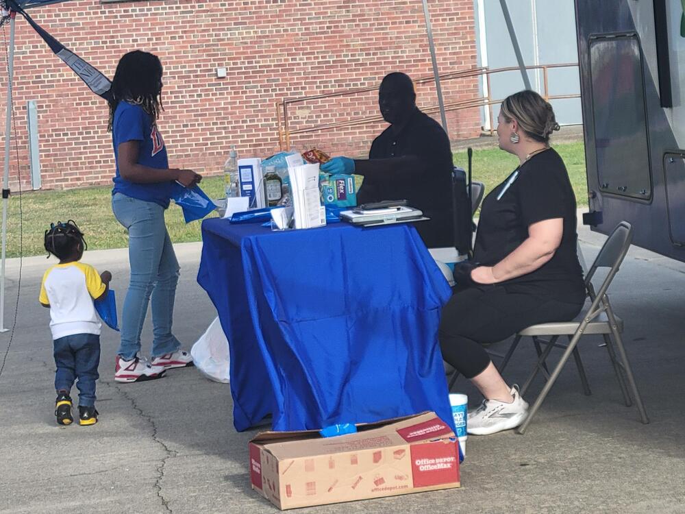 Some kids at the table for Carter Center Mobile Care Center.