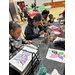 A group of kids painting at a table.