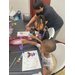 Two children painting at a table.