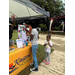 A young lady at the Kinston Housing table rolling dice to get a prize.