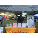 Kinston Housing sign next to their table at the National Night Out with a different lady behind it.