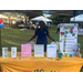 Closer view of the table at the National Night Out with a lady standing between chairs behind it.