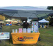 Kinston Housing sign next to their table at the National Night Out with a lady behind it.