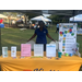 A  lady behind a table outside holding information about Kinston Housing.